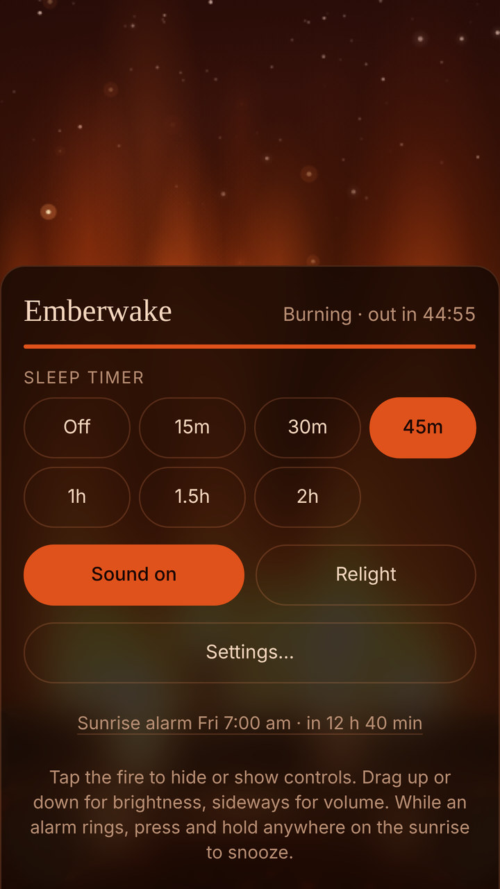 Emberwake on a phone: the controls over a glowing fire, with the sleep timer set to 45 minutes and burning, Sound on, Relight, Settings, and the next sunrise alarm at 7:00 am.